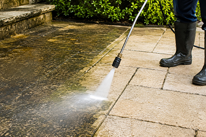 Pressure washing service in Kingston cleaning a concrete patio